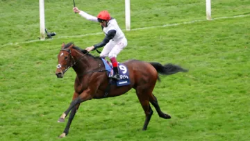 Dettori Punches the air as he wins his first Champion Stakes